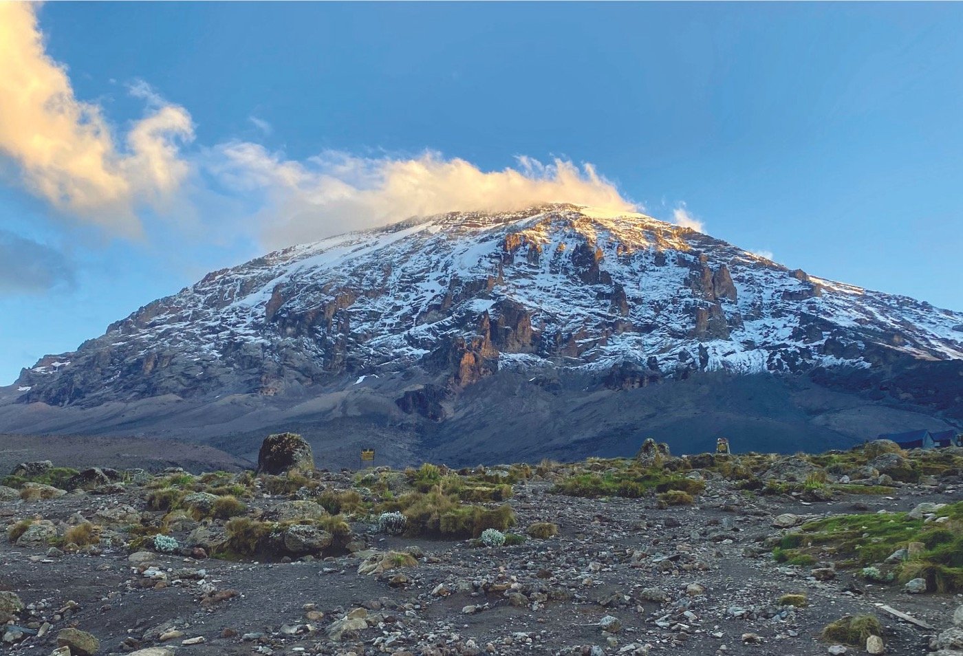 Snow-capped summit of Mount Kilimanjaro above the clouds